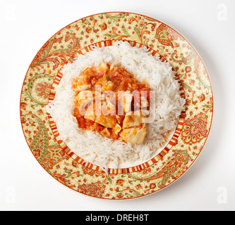 Basic fish curry, in a spicy tomato and coconut milk sauce, served on a bed of basmati rice. Stock Photo
