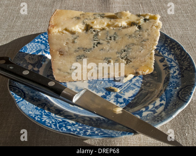 Traditional blue Stilton cheese on a traditional Spode blue-and-white printed plate in their famous 'Italian' pattern. Stock Photo