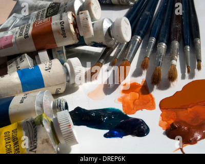 Tubes of goauche paint and sable brushes are tools of a designer or artist's trade. Stock Photo