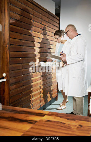 Pharmacists Working In Drugstore, Munich, Bavaria, Germany Stock Photo
