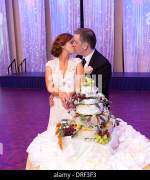 couple cutting the cake at the reception Stock Photo