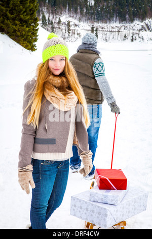 Couple Pulling Gifts On Sled, Spitzingsee, Bavaria, Germany, Europe Stock Photo