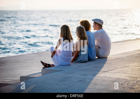 Family on boardwalk, looking at sea, Zadar, Croatia Stock Photo