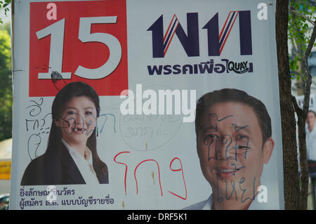Bangkok, Thailand. Jan. 24th, 2014. A defaced election poster of Yingluck Shinawatra, the current prime minister of Thailand. The Thai National elections are scheduled for Feb. 2nd. On day 12 of 'Shutdown Bangkok', vandalism & graffiti are everywhere. after almost 3 months of protesting, there are still Tens of thousands of protesters on the streets of Bangkok demanding the resignation of Thai Prime Minister Yingluck Shinawatra. 'Shutdown Bangkok' is organized by the People's Democratic Reform Committee (PDRC). Credit: Kraig Lieb / Alamy Live News Stock Photo