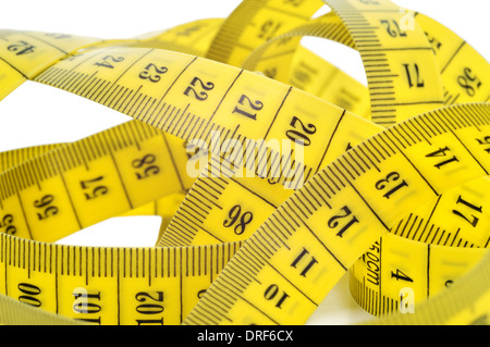 Yellow tape measure isolated on white background. Weight loose problem. Stock Photo