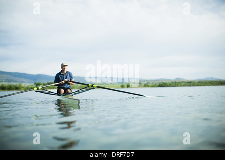 Colorado USA man in rowing boat using the oars Stock Photo