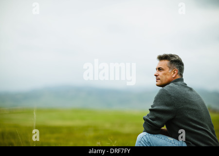 Colorado USA man sitting alone gazing deep in thought Stock Photo