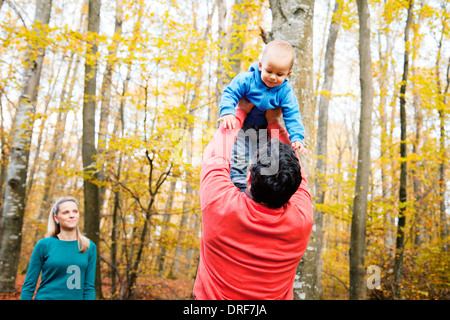 Father lifting his son up in the air, mother is watching, Osijek, Croatia Stock Photo