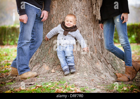 Family with son leaning against tree, Osijek, Croatia Stock Photo