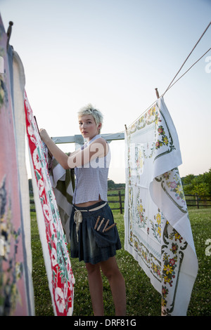 Maryland USA teenager hanging out fabrics on washing line Stock Photo