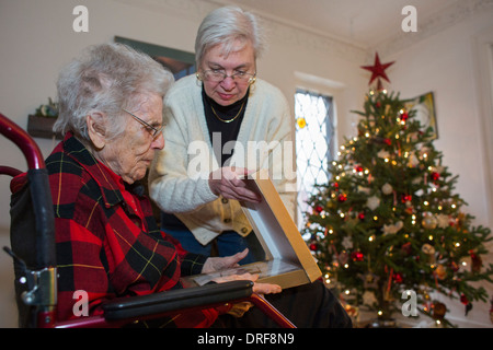 Detroit, Michigan - Dorothy Newell, 99, opens a Christmas present with the help of her daughter, Susan Newell, 65. Stock Photo