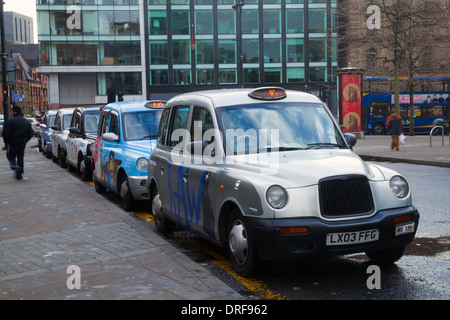 London Taxis Int Txii Bronze Auto. Colourful Piccadilly Hackney Cabs,  Private Hire Vehicles  Taxis in Manchester City Centre, UK. Stock Photo