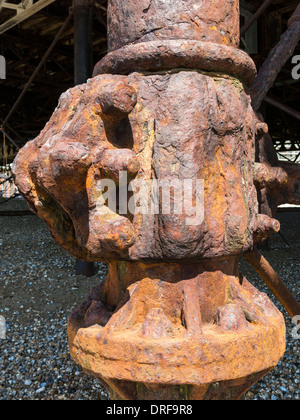 Large ruddy brown rusty cast iron corroded metal pier stanchion support, Eastbourne, East Sussex, England, UK Stock Photo