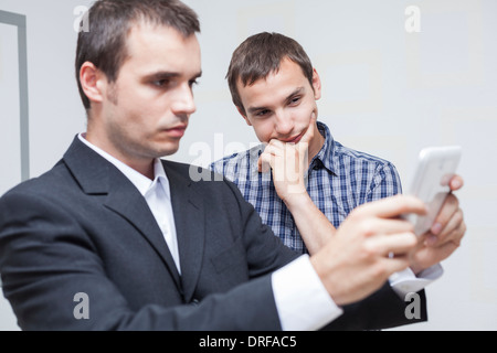 Two businessmen looking at digital tablet in the office. Stock Photo