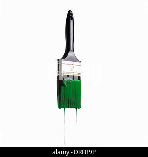 paintbrush loaded with green paint dripping Stock Photo