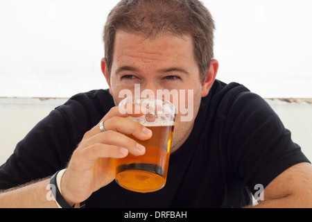 Close up of young man drinking beer. Stock Photo