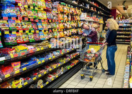 Young family shopping in a supermarket. Stock Photo