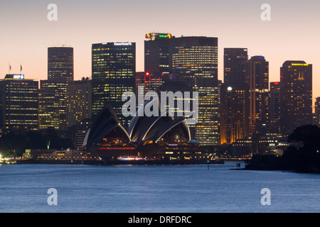 Sydney Opera House and skyline of CBD at sunset night from Cremorne Point Sydney New South Wales NSW Australia Stock Photo