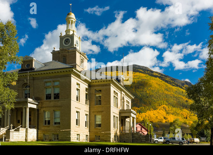 San Juan County Courthouse stands backed by autumn color on Storm Peak, Silverton, Colorado. Stock Photo