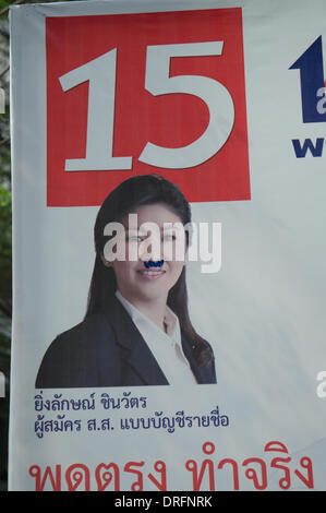 Bangkok, Thailand. Jan. 24th, 2014. Defaced Yingluck Shinawatra election poster depicting Yingluck w/ a Hitler mustache. The Thai National elections are scheduled for Feb. 2nd. after almost 3 months of protesting, there are still Tens of thousands of protesters on the streets of Bangkok demanding the resignation of Thai Prime Minister Yingluck Shinawatra. 'Shutdown Bangkok' is organized by the People's Democratic Reform Committee (PDRC). Credit:  Kraig Lieb / Alamy Live News Stock Photo