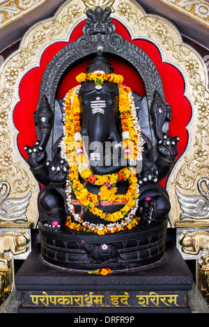 Stone Ganesha statue inside the prayer hall at Sathya Sai Baba Super Speciality hospital. Puttaparthi, Andhra Pradesh, India Stock Photo