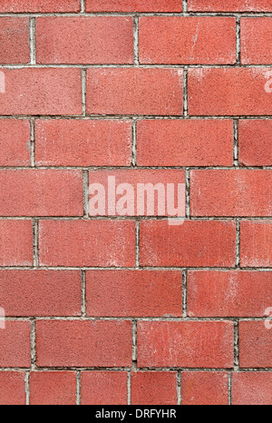 Modern red brick wall background with cracks in concrete Stock Photo