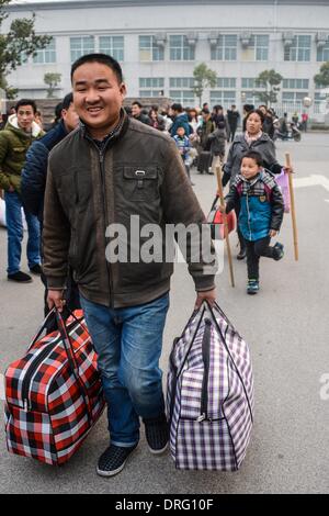 Anji, China's Zhejiang Province. 25th Jan, 2014. A worker of Henglin Chair Industry, a local private company, prepares to board a chartered bus to return home in Anji County, east China's Zhejiang Province, Jan. 25, 2014. Henglin chartered 20 buses to send its workers home for free for family reunion prior to the Spring Festival, which falls on Jan. 31 this year. © Xu Yu/Xinhua/Alamy Live News Stock Photo