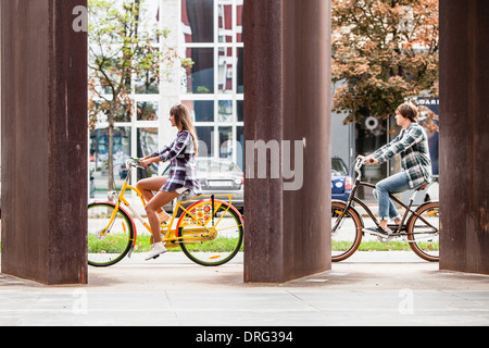 Young couple riding bicycles together, Osijek, Croatia Stock Photo