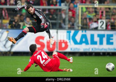 Freiburg, Germany. 25th Jan, 2014. Leverkusen's Gonzalo Castro (TOP) vies for the ball with Freiburg's Mensur Mujdza during the Bundesliga soccer match SC Freiburg vs Bayer Leverkusen at Mage-Solar-Stadion in Freiburg, Germany, 25 January 2014. Photo: Uwe Anspach/dpa (ATTENTION: Due to the accreditation guidelines, the DFL only permits the publication and utilisation of up to 15 pictures per match on the internet and in online media during the match.)/dpa/Alamy Live News