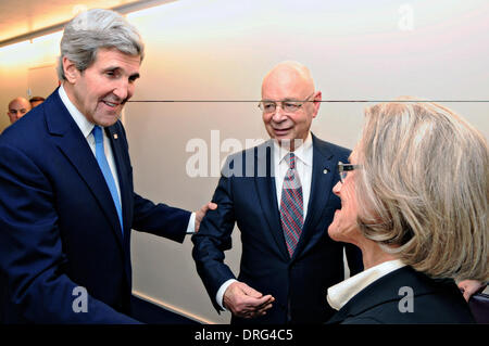 US Secretary of State John Kerry is greeted by Klaus and Hilde Schaub, the co-hosts of the World Economic Forum, before delivering the keynote address at the annual gathering January 24, 2014 in Davos, Switzerland. Stock Photo