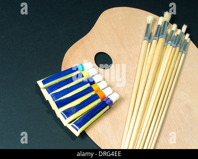 An image showing an artists equipment, Paint palette, brushes and paints Stock Photo