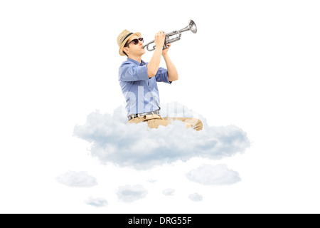 Young male musician playing a trumpet on clouds Stock Photo