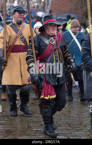 Nantwich, Cheshire, UK 25th January, 2014. Raining on the parade at Holly Holy Day & Siege of Nantwich re-enactment.  For over 40 years the faithful troops of The Sealed Knot have gathered in the historic town for a spectacular re-enactment of the bloody battle that took place almost 400 years ago and marked the end of the long and painful siege of the town.  Roundheads, cavaliers, and other historic entertainers converged upon the town centre to re-enact the Battle. The siege in January 1644 was one of the key conflicts of the English Civil War. Credit:  Conrad Elias/Alamy Live News Stock Photo