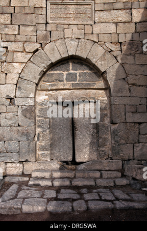 A basalt doorway at the ruins of Qasr al-Azraq built by the Ayyubids in the 13th century using locally quarried basalt located in the province of Zarqa Governorate in central-eastern Jordan Stock Photo