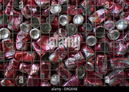 Empty Coca Cola cans with Arabic logo in a recycle container Stock Photo