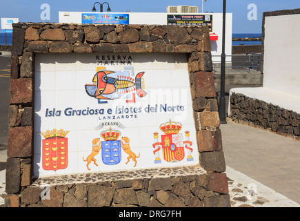 Marine Reserve sign for Isla Graciosa by the ferry port for islands off the north coast. Orzola, Lanzarote, Canary Islands Stock Photo