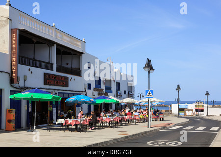 People dining outside a pavement cafe in most northern village resort of Orzola, Lanzarote, Canary Islands, Spain Stock Photo