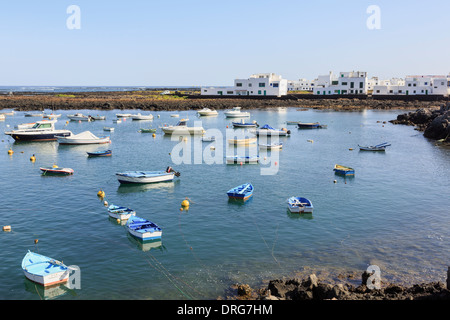 Boats moored in the small harbour on north coast port of Orzola, Lanzarote, Canary Islands, Spain Stock Photo