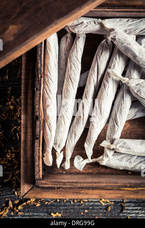 Handmade cigarettes in wooden box Stock Photo