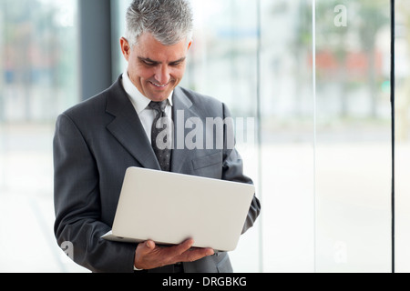 happy senior businessman using laptop computer at work Stock Photo