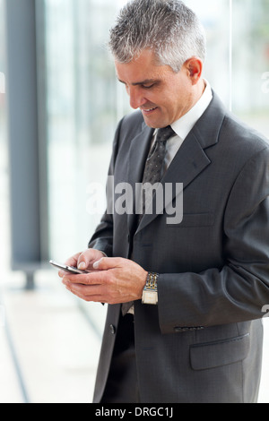 senior businessman texting using mobile phone Stock Photo
