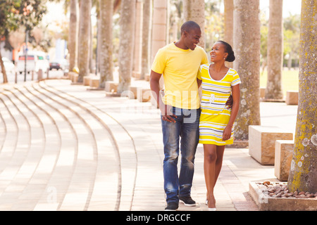 cheerful young afro American couple walking on urban street Stock Photo