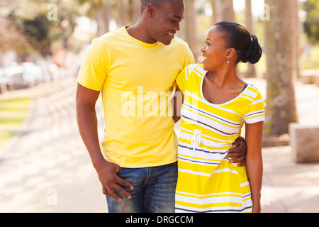 beautiful black young couple walking in the street