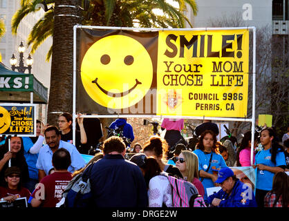 San Francisco, USA. 25th Jan, 2014.  San Francisco, USA. 25th Jan, 2014. Diverse crowd of Pro life  Anti abortion marchers  carry signs on 10th annual walk for life on the embarcadero in San Francisco. Pictured: Anti abortion protesters hold sign saying smile your mom chose life .San Francisco California Credit:  Bob Kreisel/Alamy Live News Stock Photo