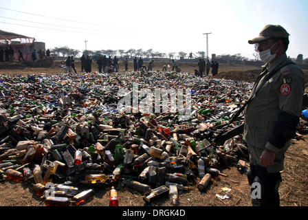 Lahore. 26th Jan, 2014. A Pakistani paramilitary soldier stands guard beside bottles of liquor to be destroyed in eastern Pakistan's Lahore on Jan. 26, 2014, during a destruction ceremony to mark the International Customs Day. Credit:  Sajjad/Xinhua/Alamy Live News Stock Photo