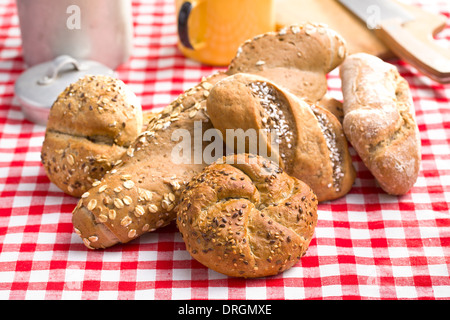 various breads on red checkered tablecloth Stock Photo
