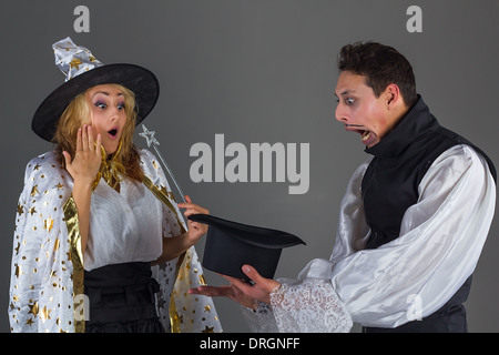 Magician man and fairy girl surprises of hat Stock Photo