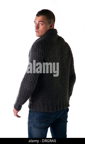 Attractive young man with wool sweater and jeans seen from the back, isolated on white background Stock Photo