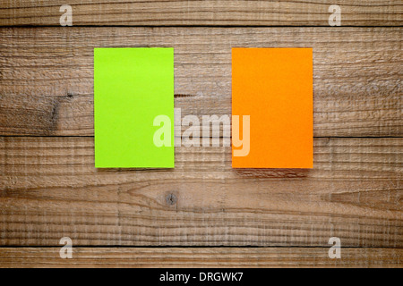 Two post-it notes on wooden background Stock Photo