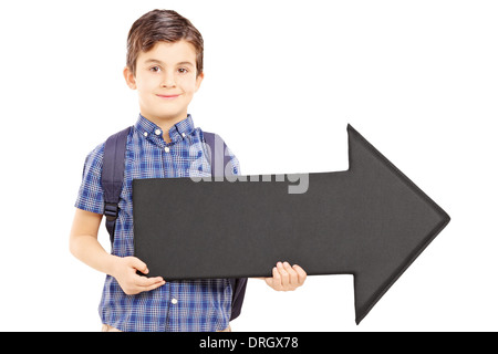 Boy with school bag holding a big black arrow pointing right, Stock Photo